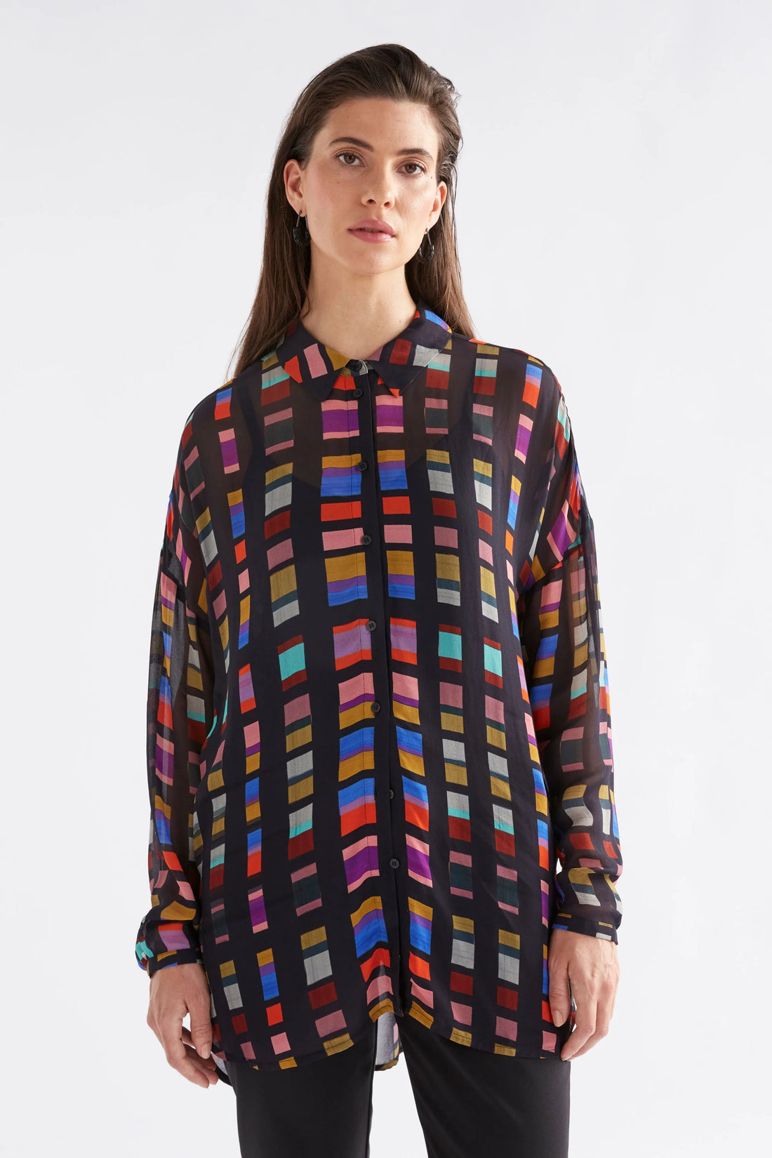 woman wearing Eir Sheer Shirt in tessela print and black pants