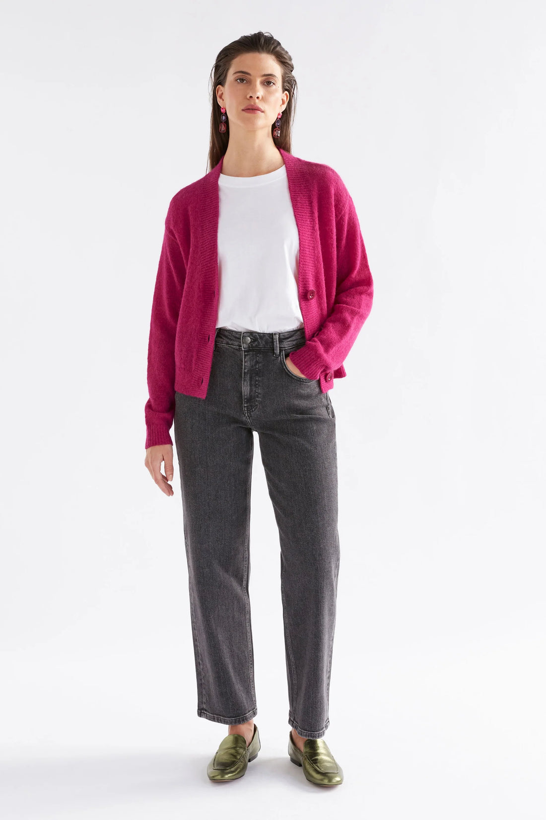 Woman wearing white top with Daru Cardigan in Bright pink and black denim pants