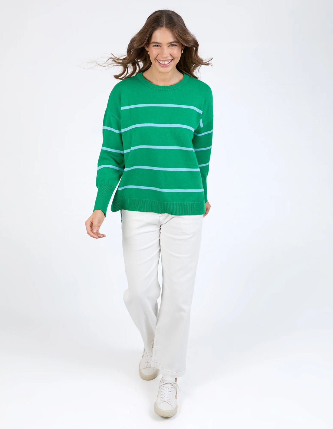 Woman wearing Charli Stripe Knit - Pine Green and white pants front view