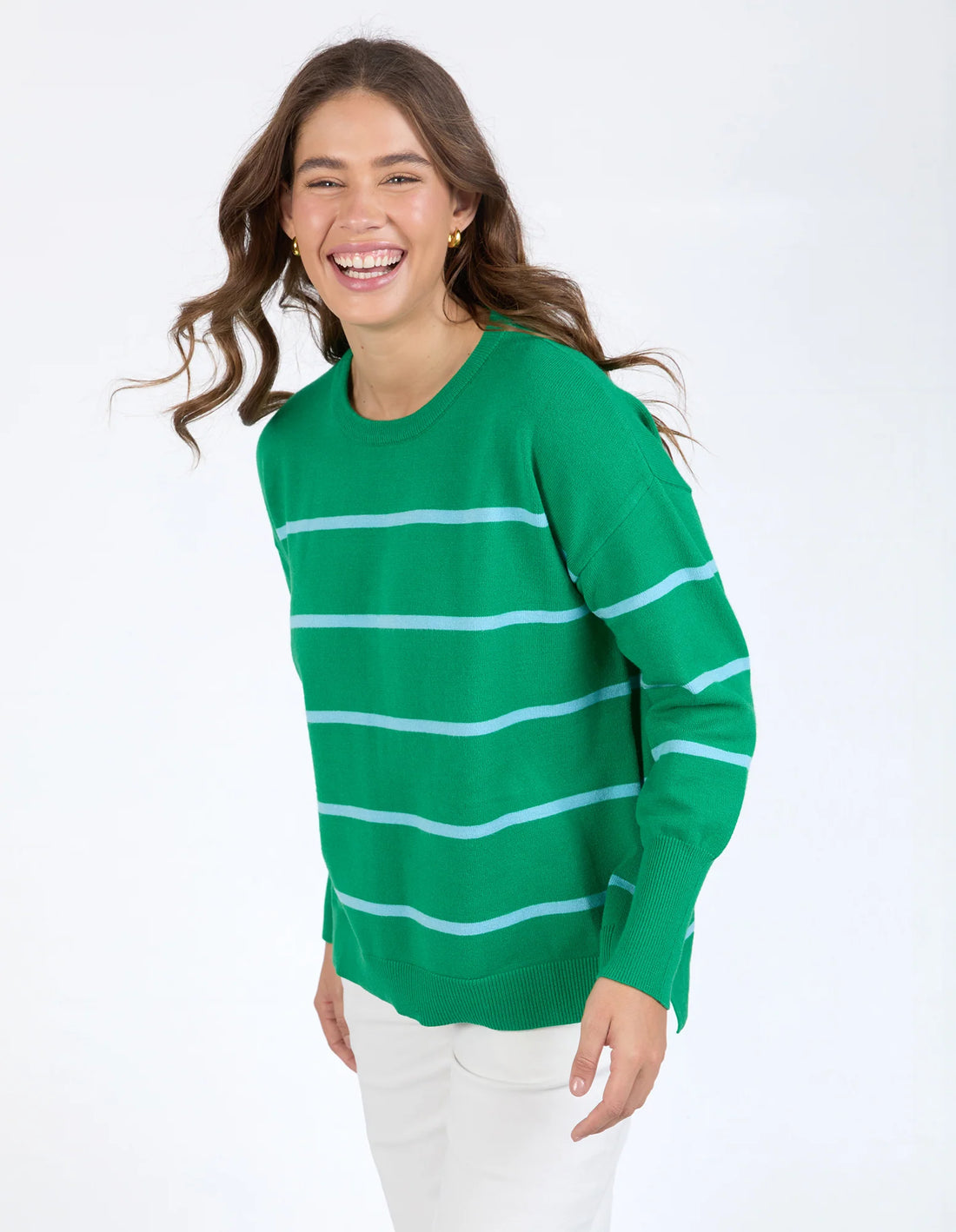 Woman wearing Charli Stripe Knit - Pine Green and white pants