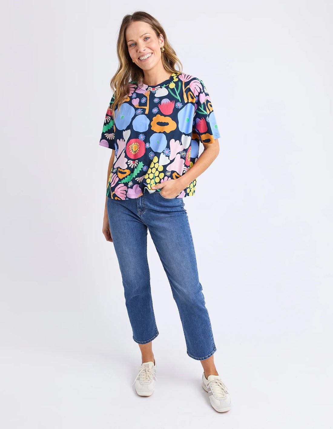 Woman wearing Flower Medley Tee - Multi and denim pants front view