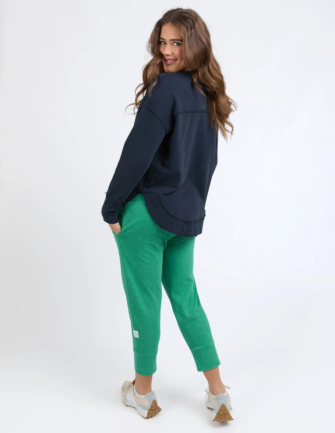 Woman wearing Madeleine Stamer Crew Navy and green pants back view