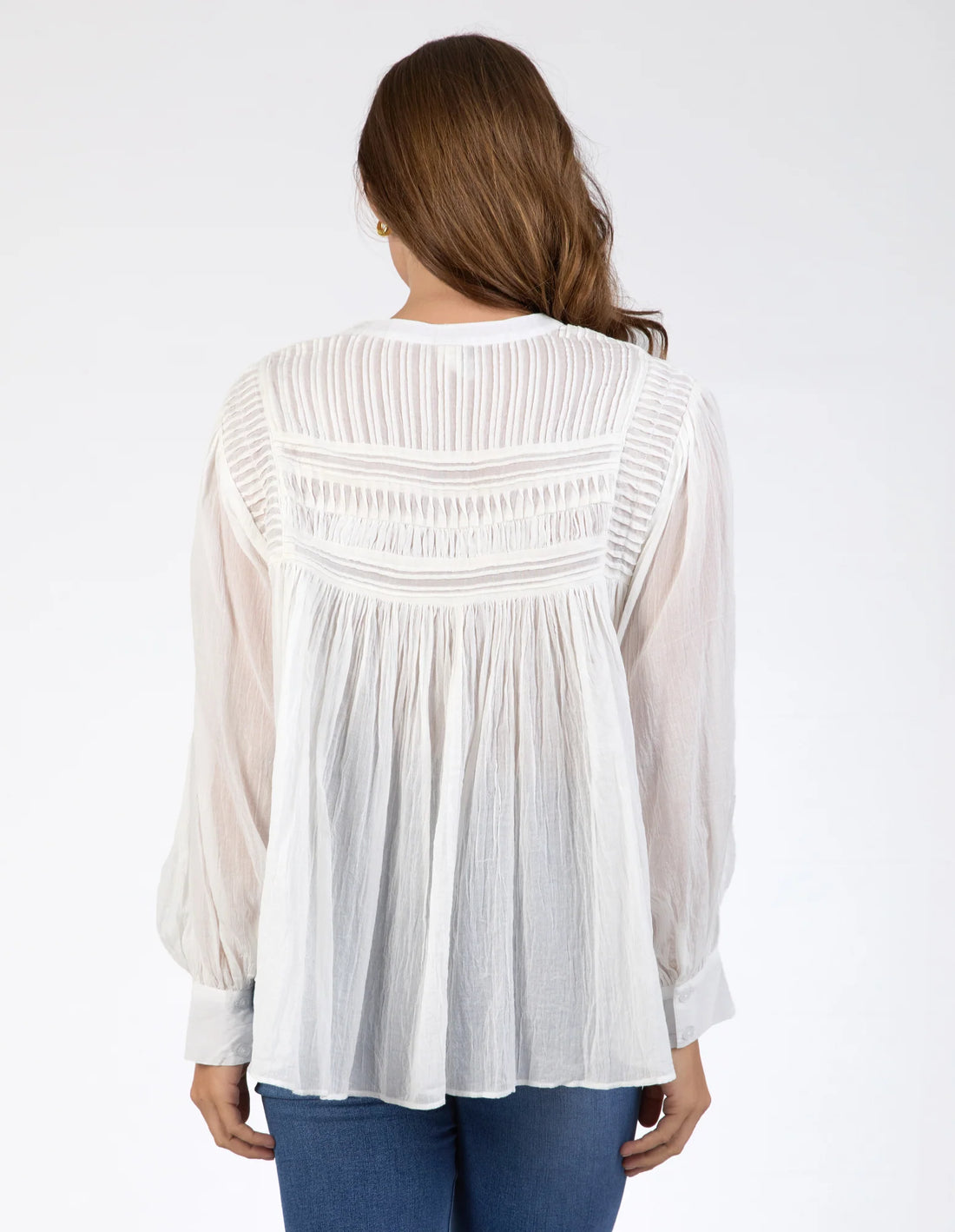 Woman wearing Montana Blouse - Marshmallow and denim pants back view
