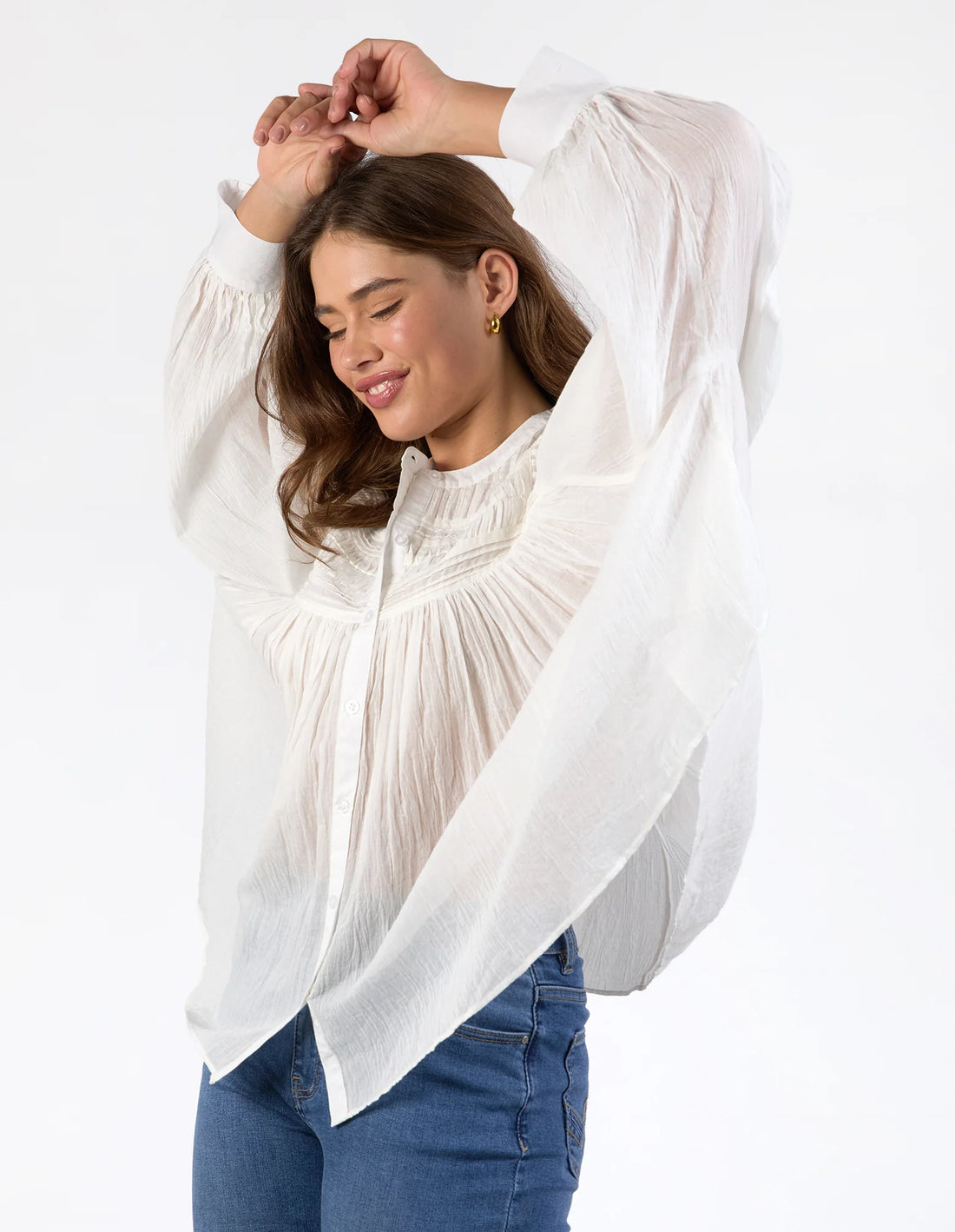Woman wearing Montana Blouse - Marshmallow her hands at the top her head