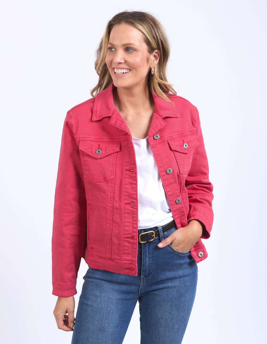 woman wearing white top, elm lifestyle tilly denim jacket in bittersweet red, denim pants with black belt