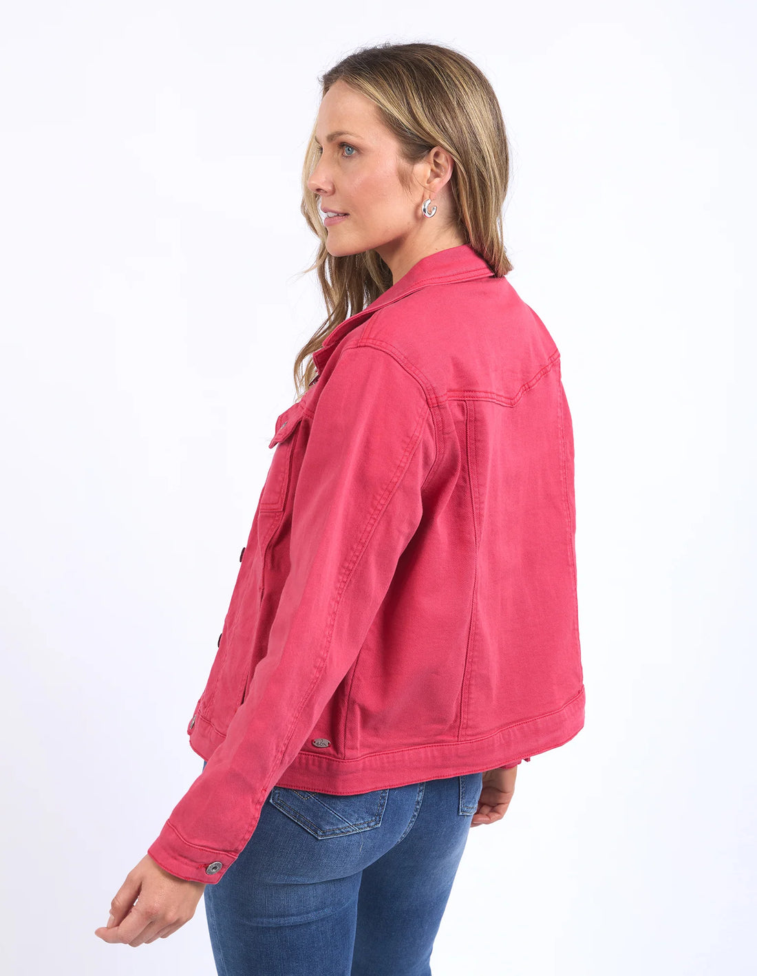 woman facing the back wearing elm lifestyle tilly jacket in bittersweet red and denim pants