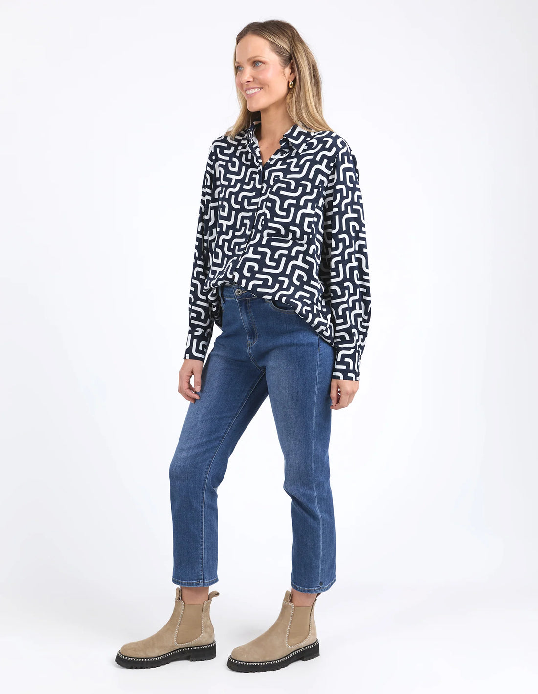 Woman wearing Gemma Geo Shirt - Navy and denim pants facing the side