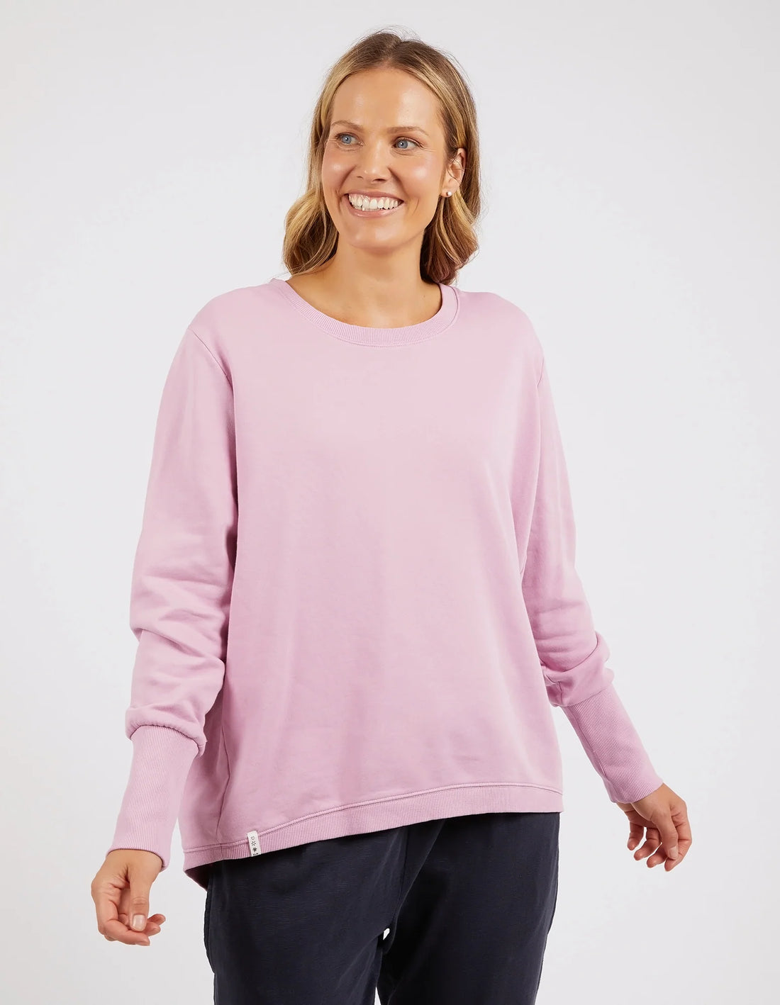 Woman wearing Divine Crew Peony Pink and black pants