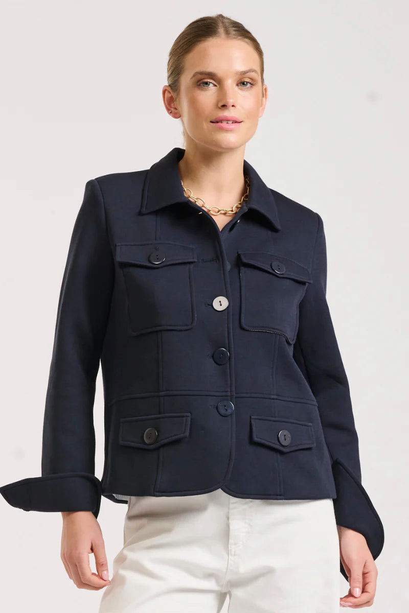 Woman wearing Hemming Scuba Jacket - French Navy and white pants