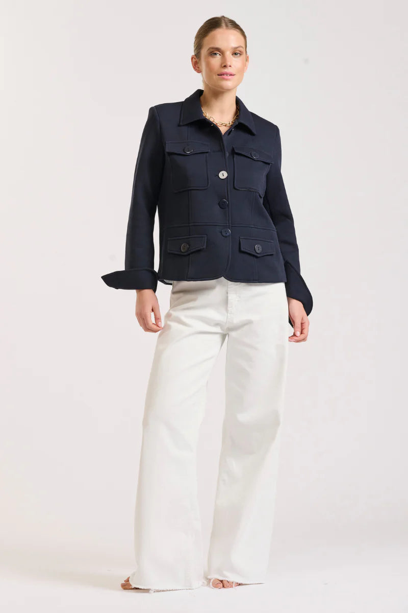 Woman wearing Hemming Scuba Jacket - French Navy and white pants