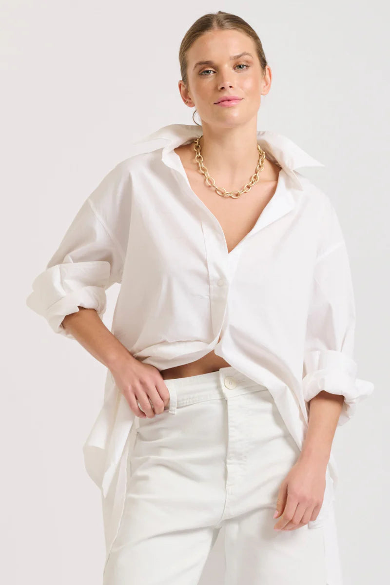 woman wearing shirty the boyfriend oversized shirt in shite and white pants