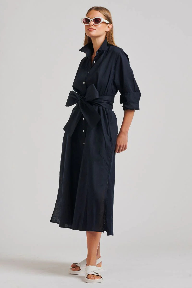 woman wearing shirty the luna oversized linen long shirtdress with black belt and white slippers