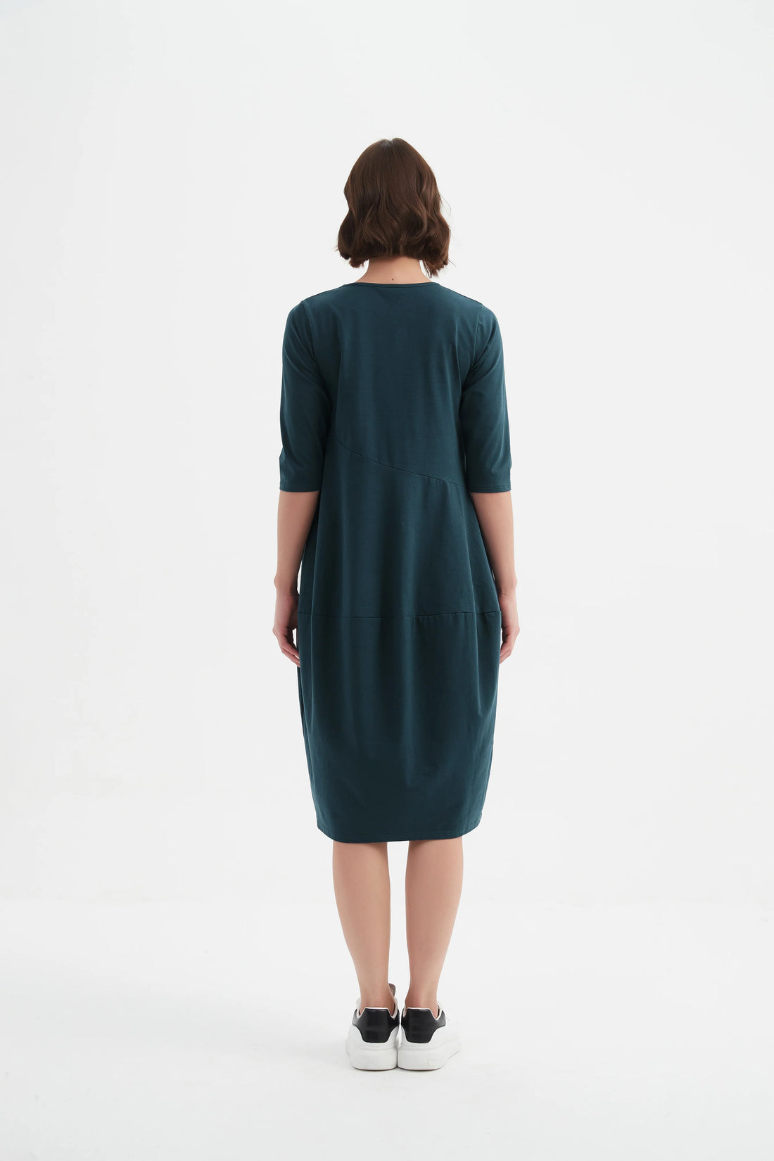 woman wearing Diagonal Seam Winter Dress - Deep Ocean facing the back