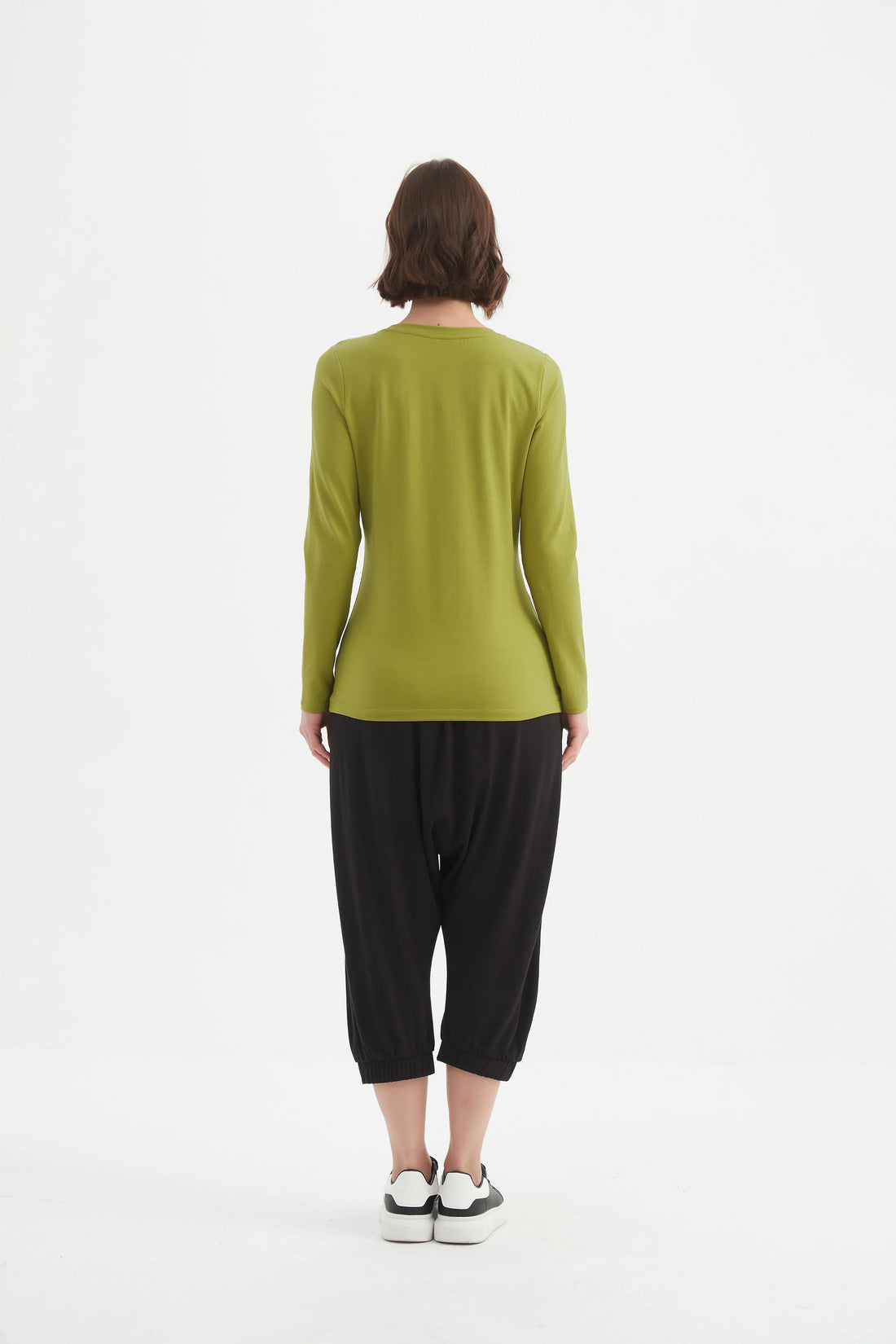 Woman wearing Long Sleeve Tshirt - Chartreuse and black pants facing the back