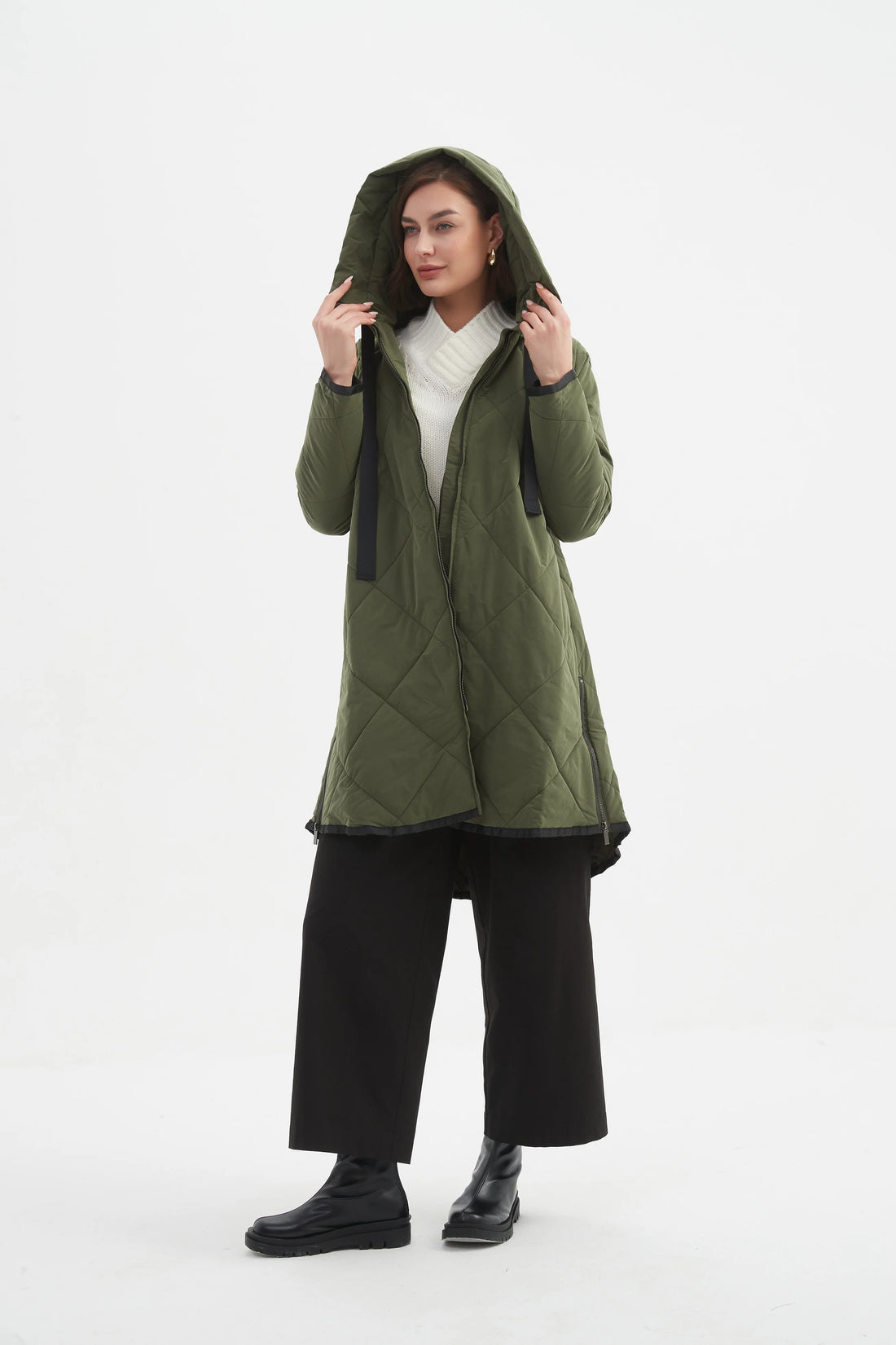Woman wearing white top and black pants with Zip Hem Winter Coat - Dark Olive