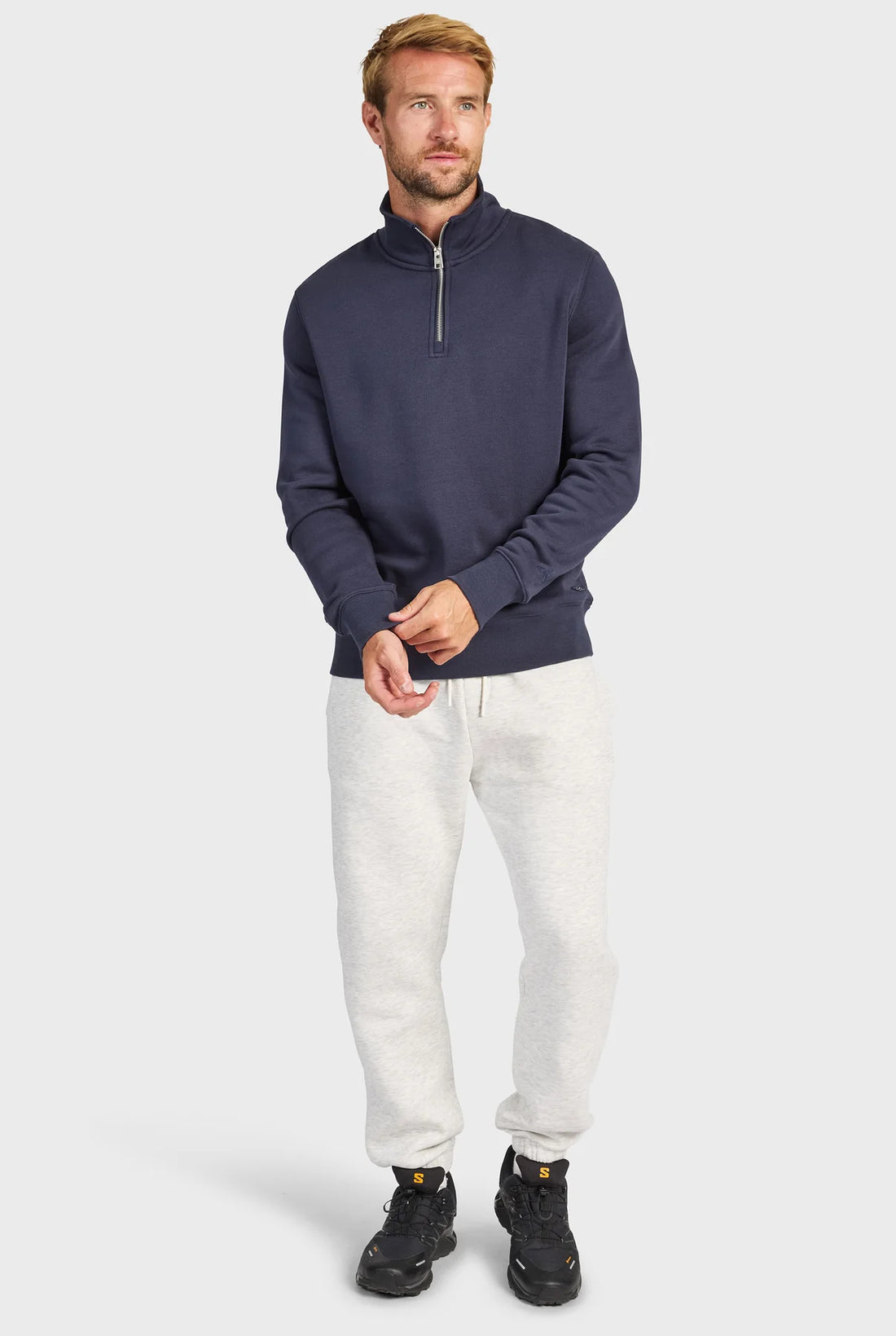man wearing 1/4 Zip Sweat - Navy and grey pants