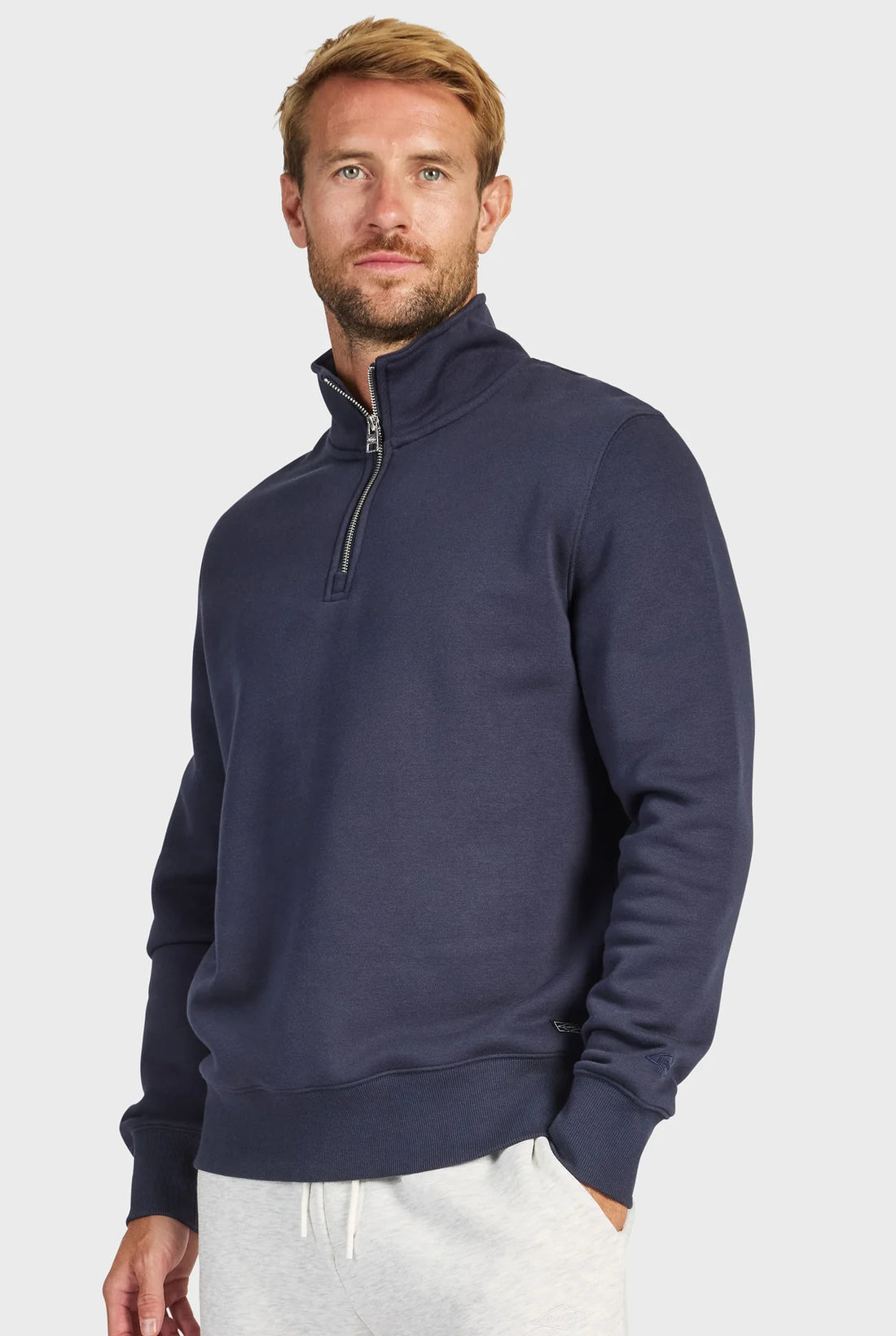 man wearing 1/4 Zip Sweat - Navy and grey pants