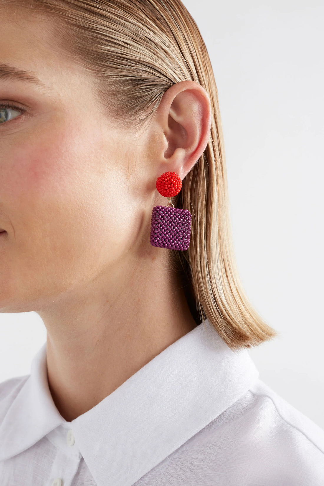 woman wearing white shirt and elk gara long drop earring mulberry