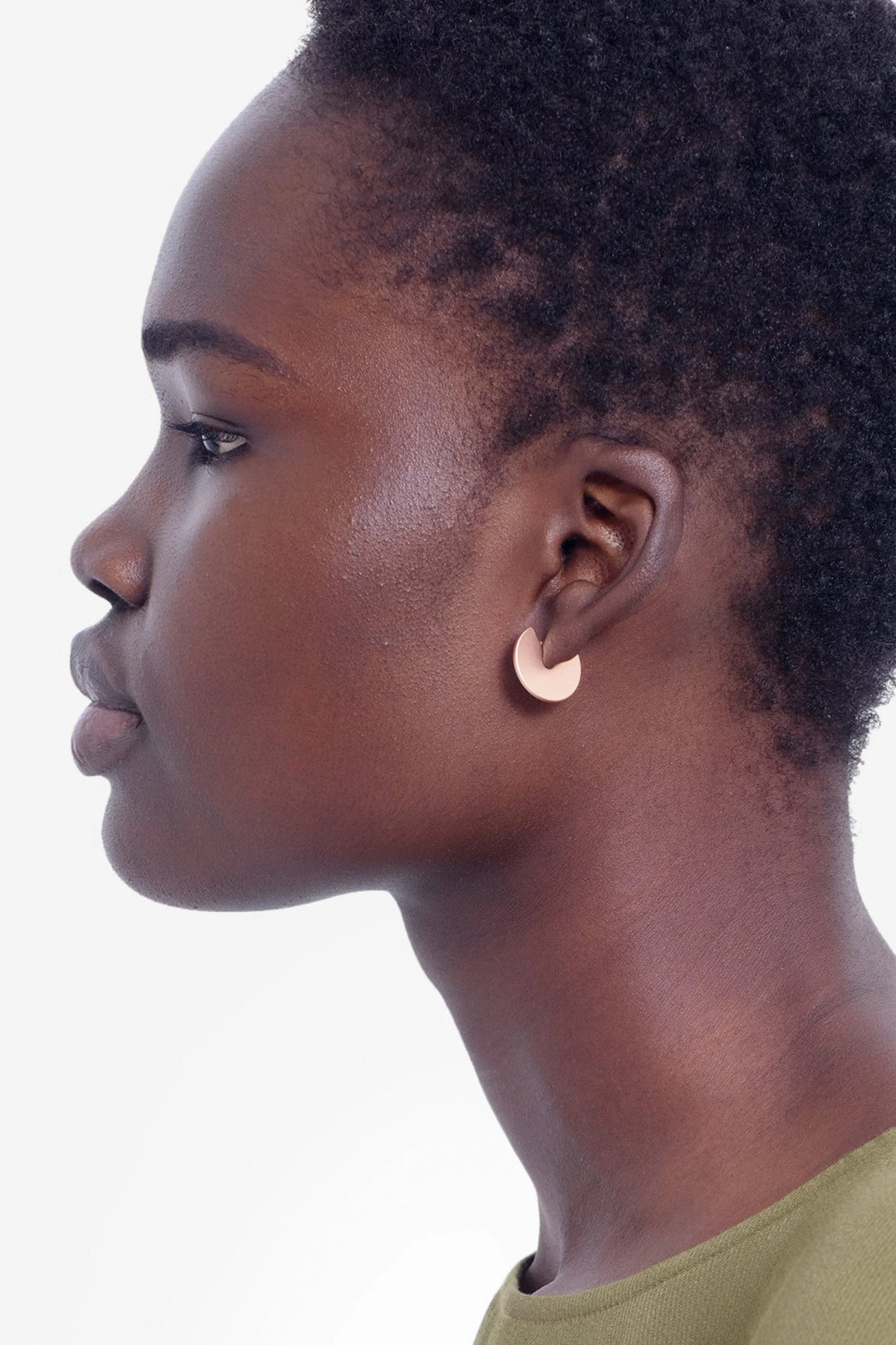 woman wearing green top and elk vivi earring in gold