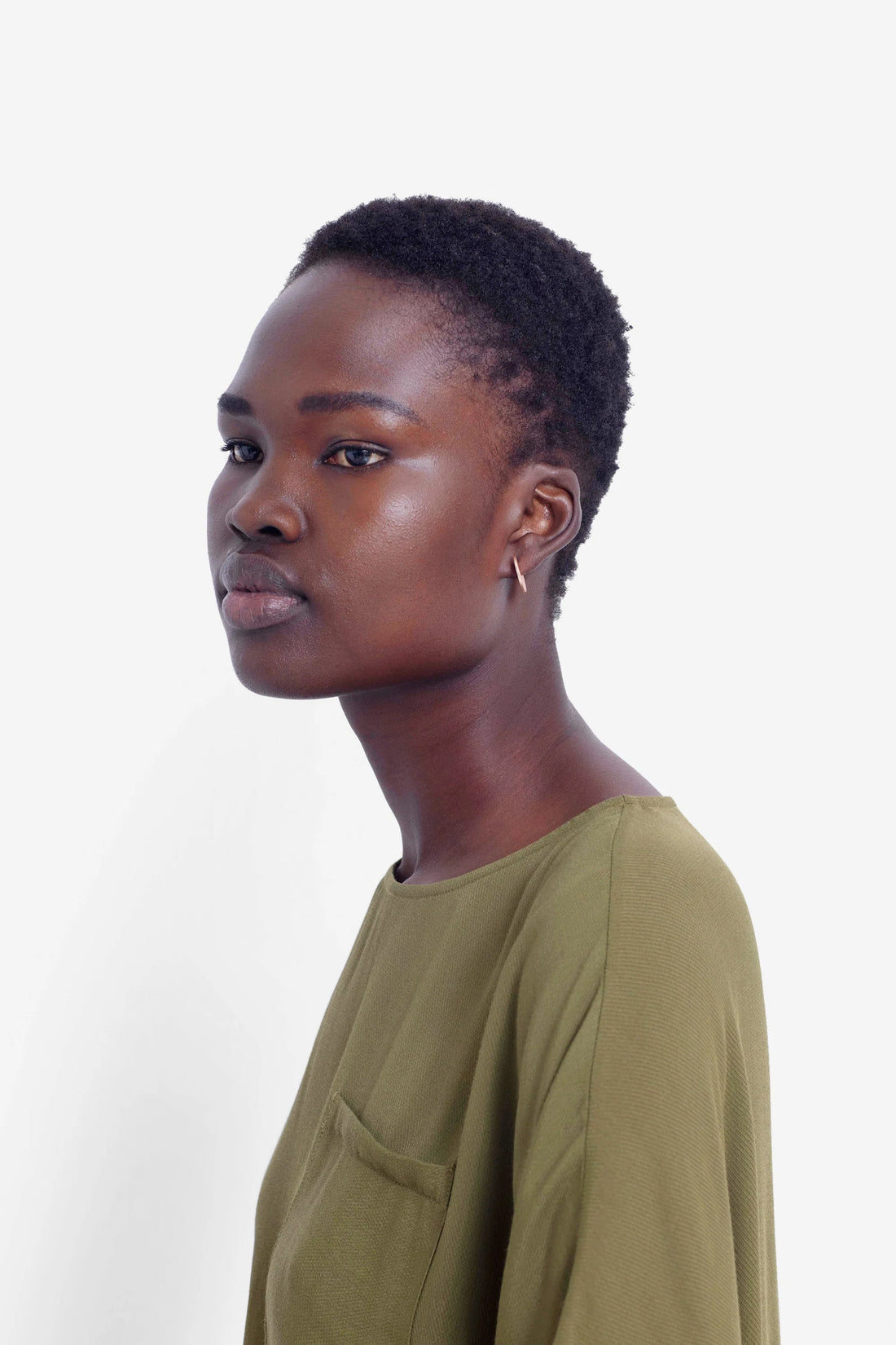 woman wearing green top and elk vivi earring in gold