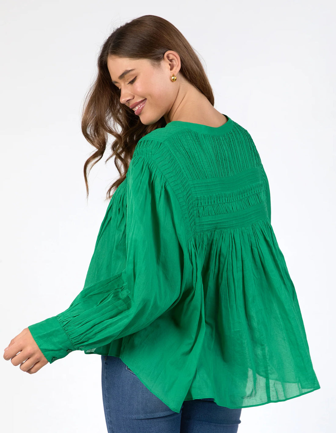 woman wearing Montana Blouse - Pine Green and denim pants back view