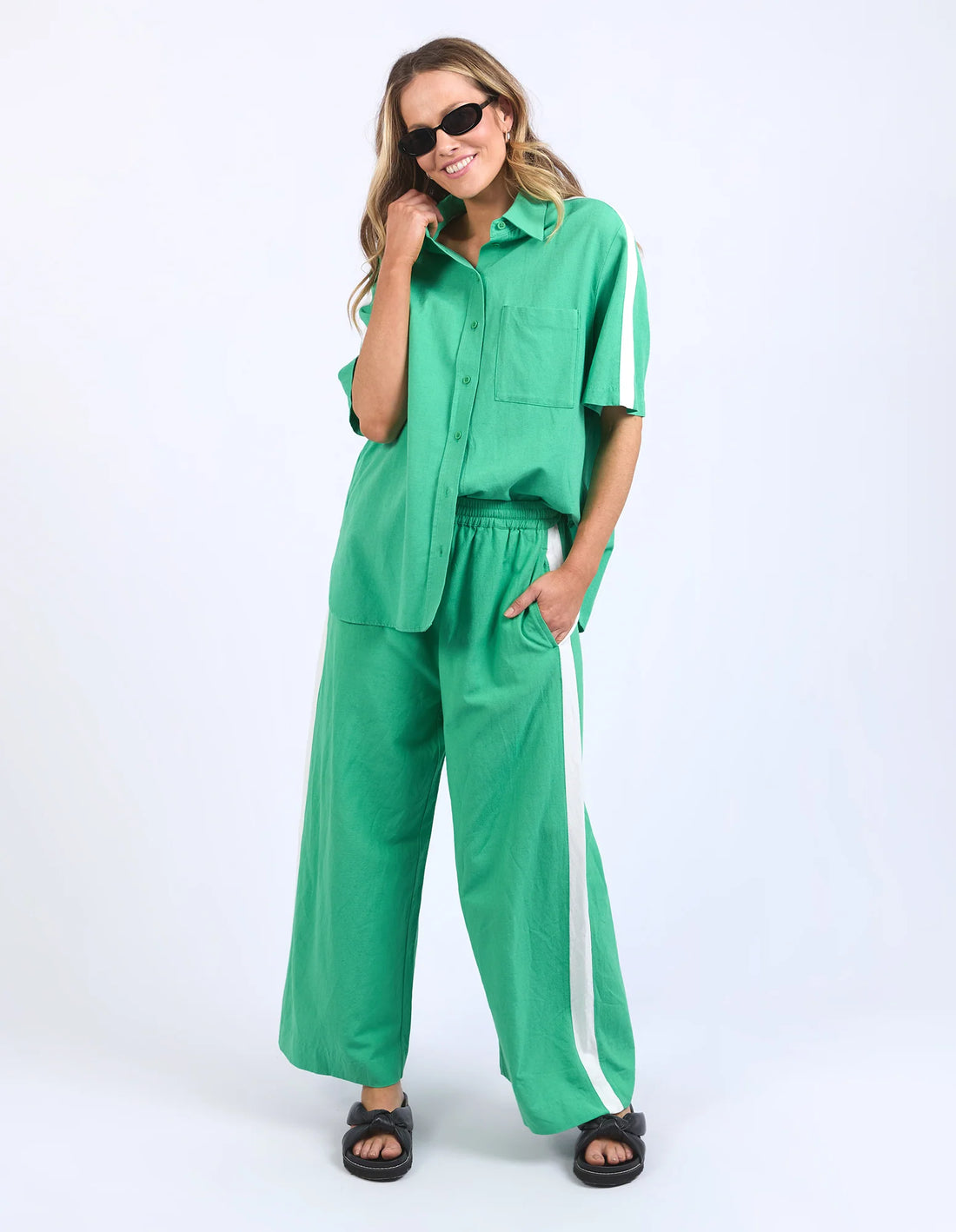 woman in black shade wearing frances stripe top, frances stripe pant greenbriar and black slippers