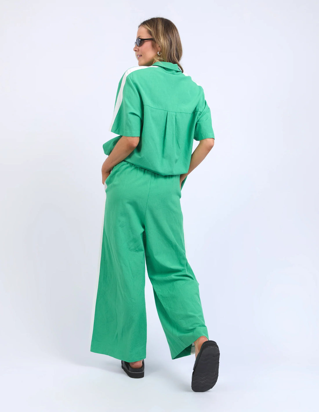 woman facing the back wearing elm lifestyle frances strip pant greenbriar and top