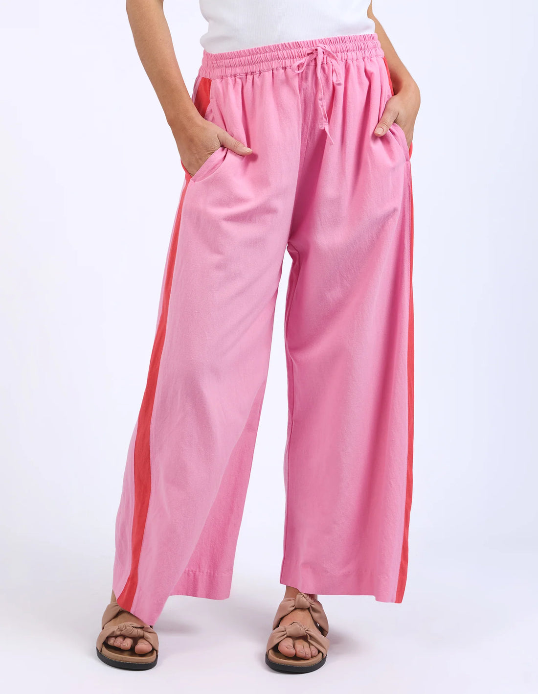 hands inside the pocket of elm lifestyle frances stripe pant strawberry
