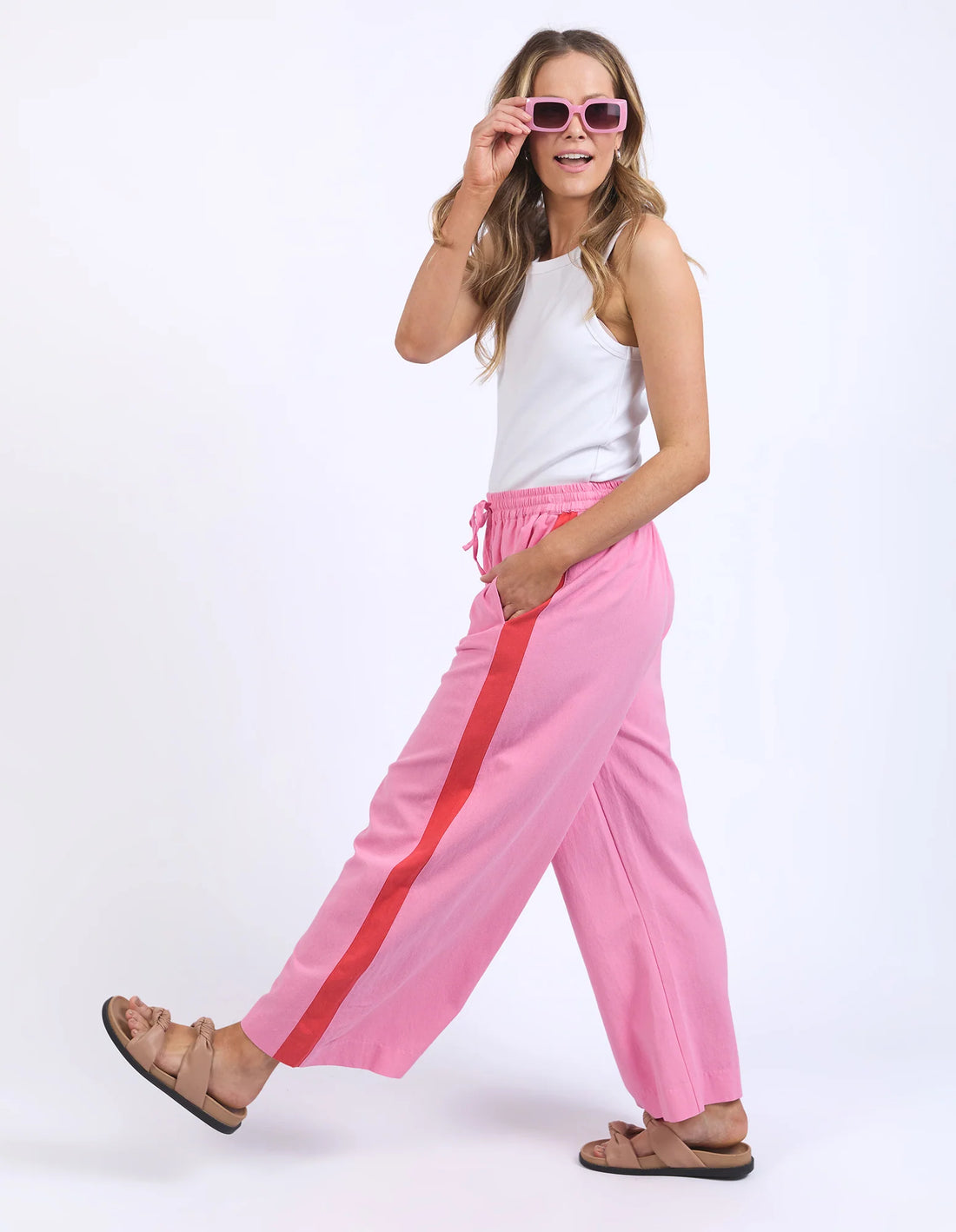 woman wearing white sleeveless top, elm lifestyle frances stripe pant strawberry pink
