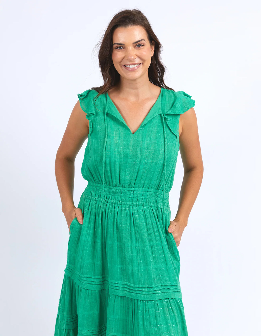 woman wearing elm lifestyle isabella dress greenbriar, while her hands on the dress pocket