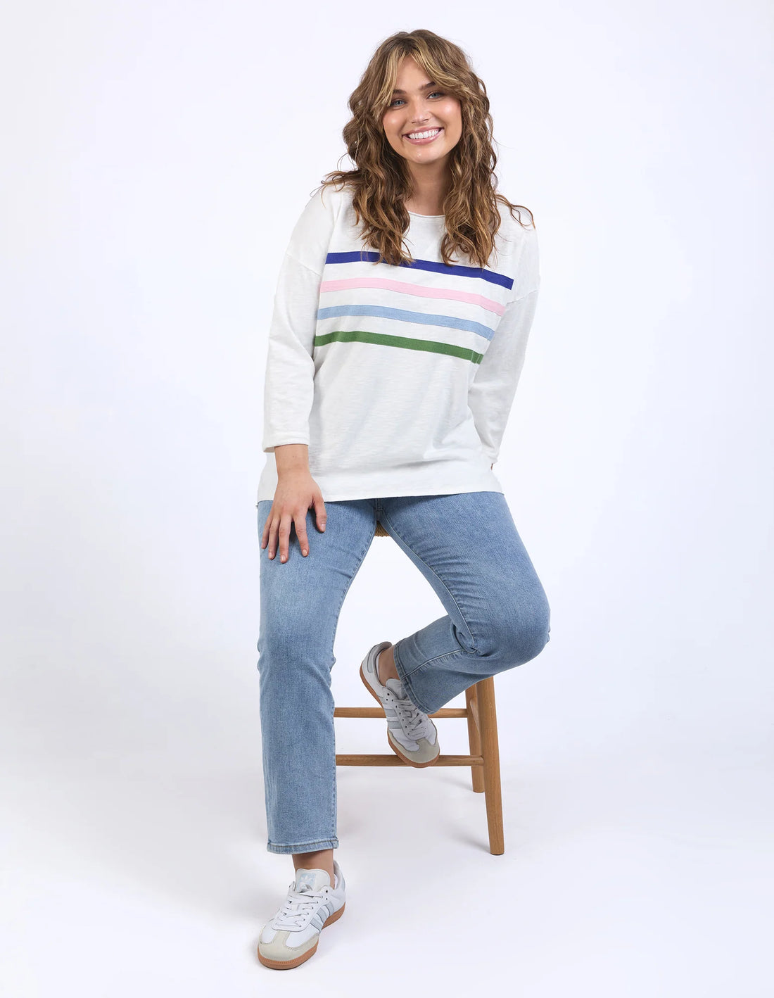 woman sitting wearing Outlook Sweat - Marshmallow and denim pants