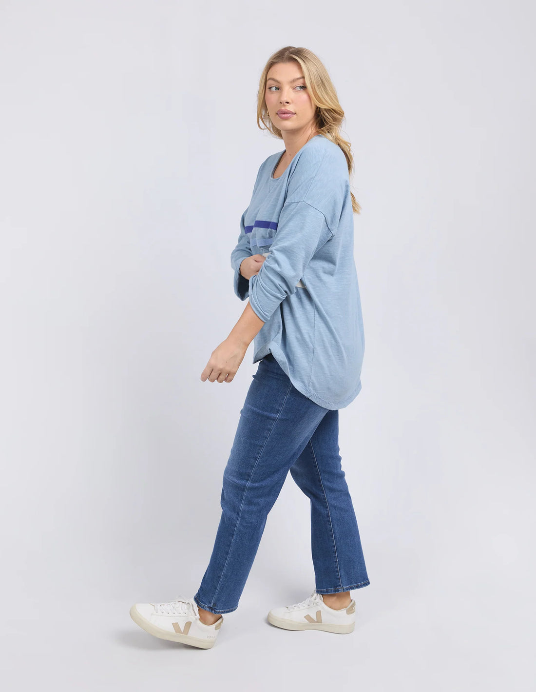 woman wearing Outlook Sweat - Steel Blue and denim pants facing the side
