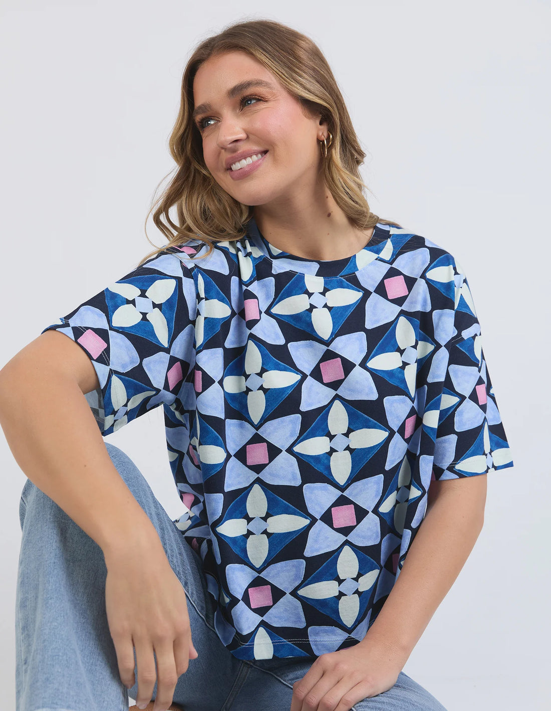 woman smiling sitting wearing elm lifestyle painted tile tee geo print