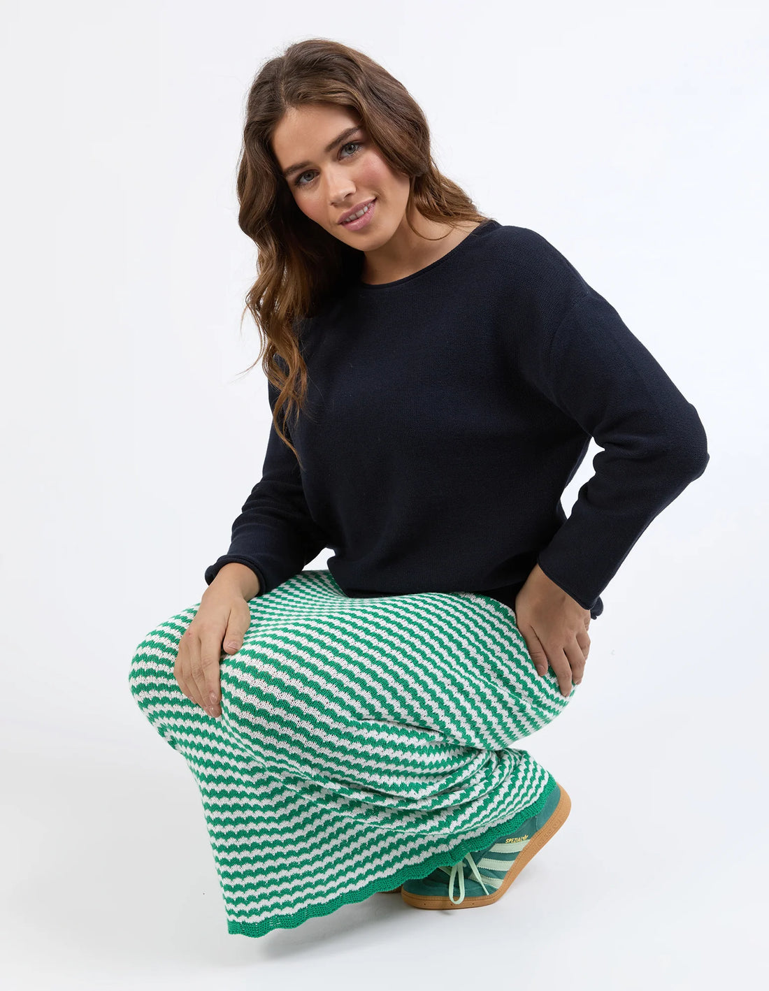 woman wearing navy jumper and Rosie Stripe Skirt - Pine Green while sitting