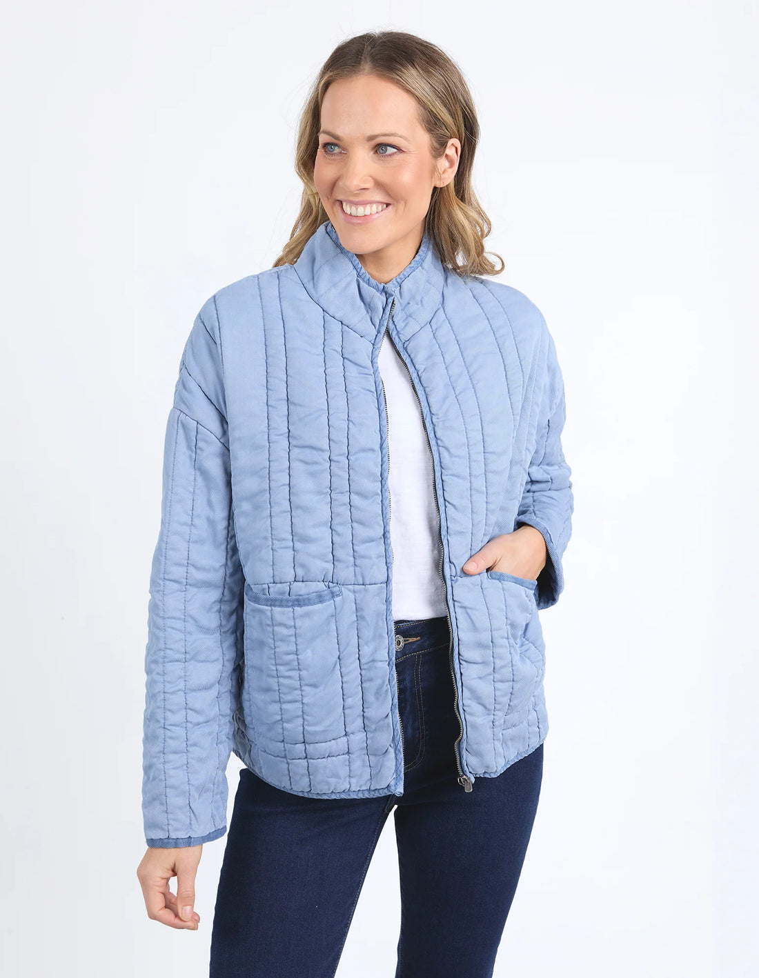 woman wearing white top, denim pants and Sparrow Quilted jacket Steel Blue