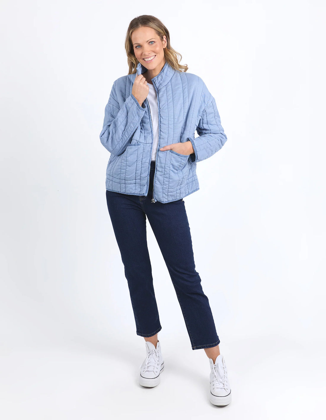 woman wearing white top, denim pants and Sparrow Quilted jacket Steel Blue