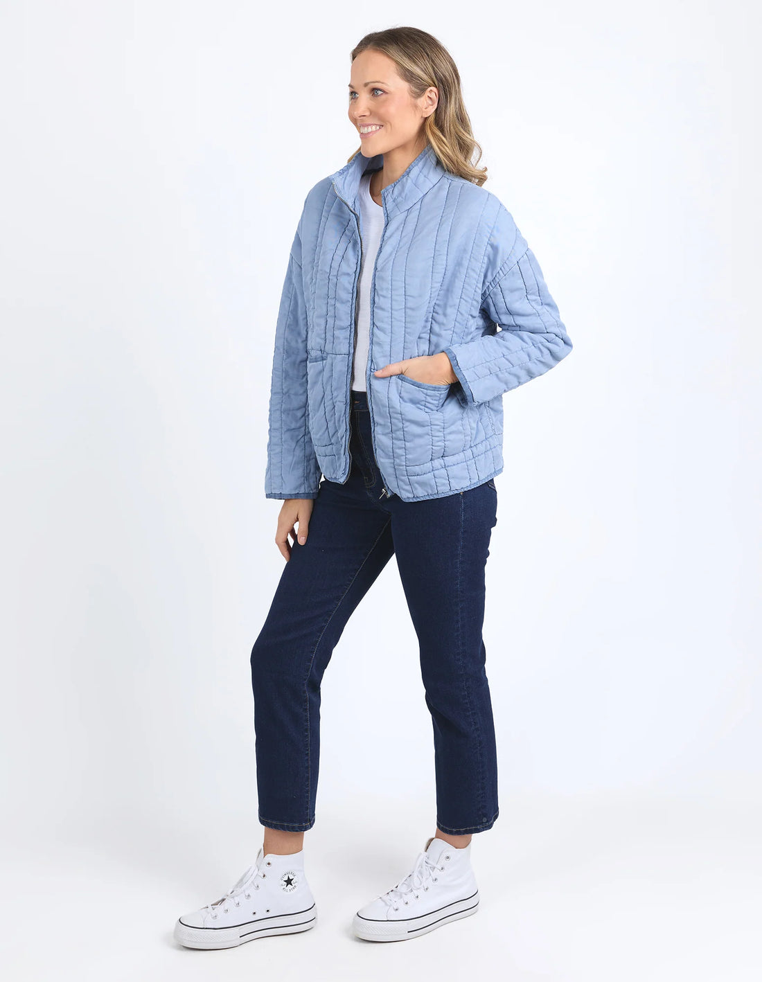 woman wearing white top, denim pants and Sparrow Quilted jacket Steel Blue