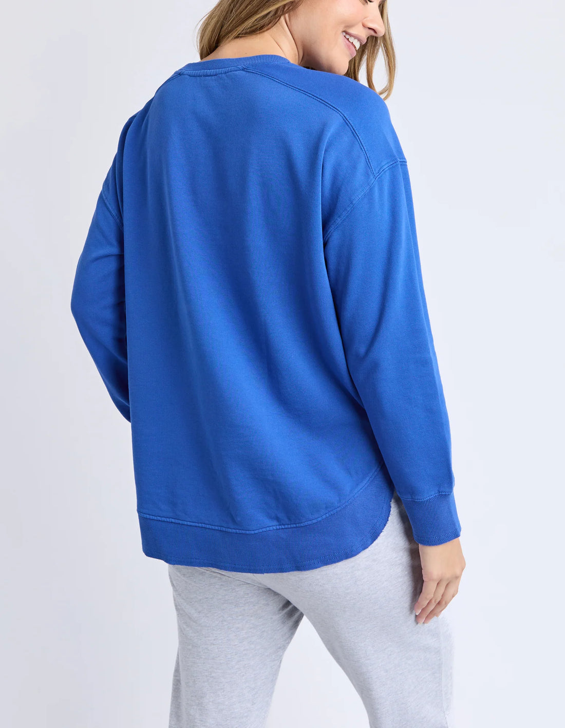 Woman facing the back wearing Established Crew - French Blue and grey jogger pants