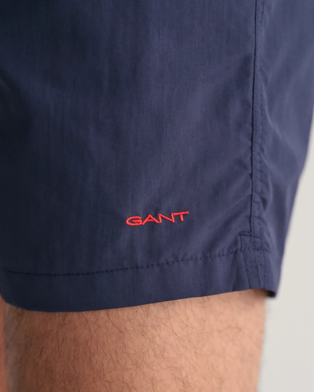 gant embroidery near the hem of the basic swim shorts in marine