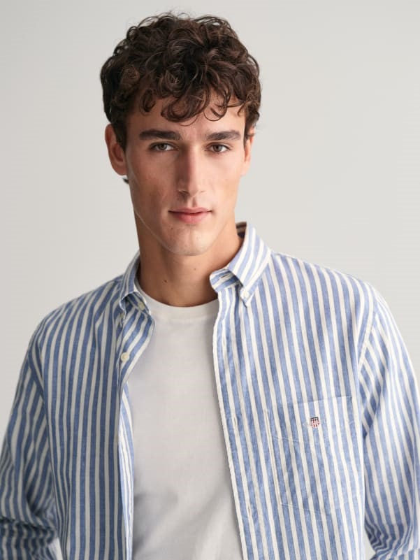 man wearing white shirt with gant cotton linen-stripe shirt in rich blue
