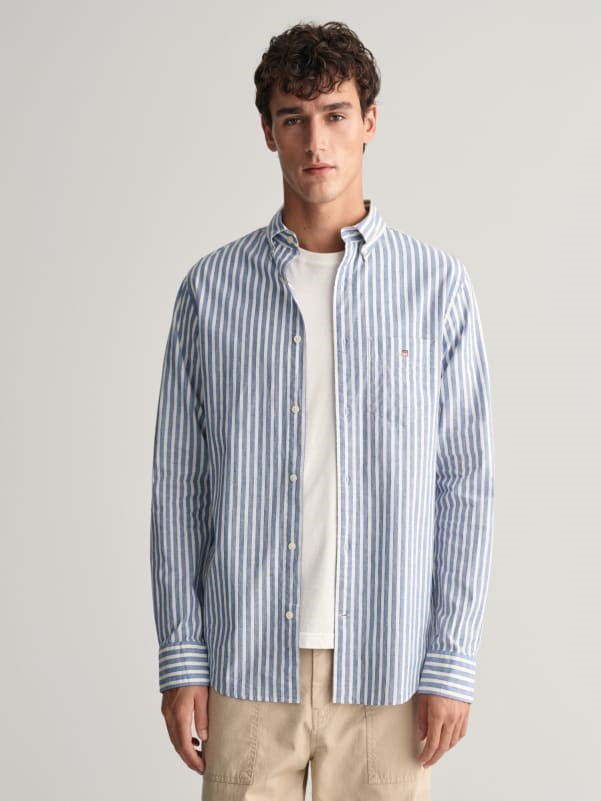 man wearing white shirt with gant cotton linen-stripe shirt in rich blue, khaki pants