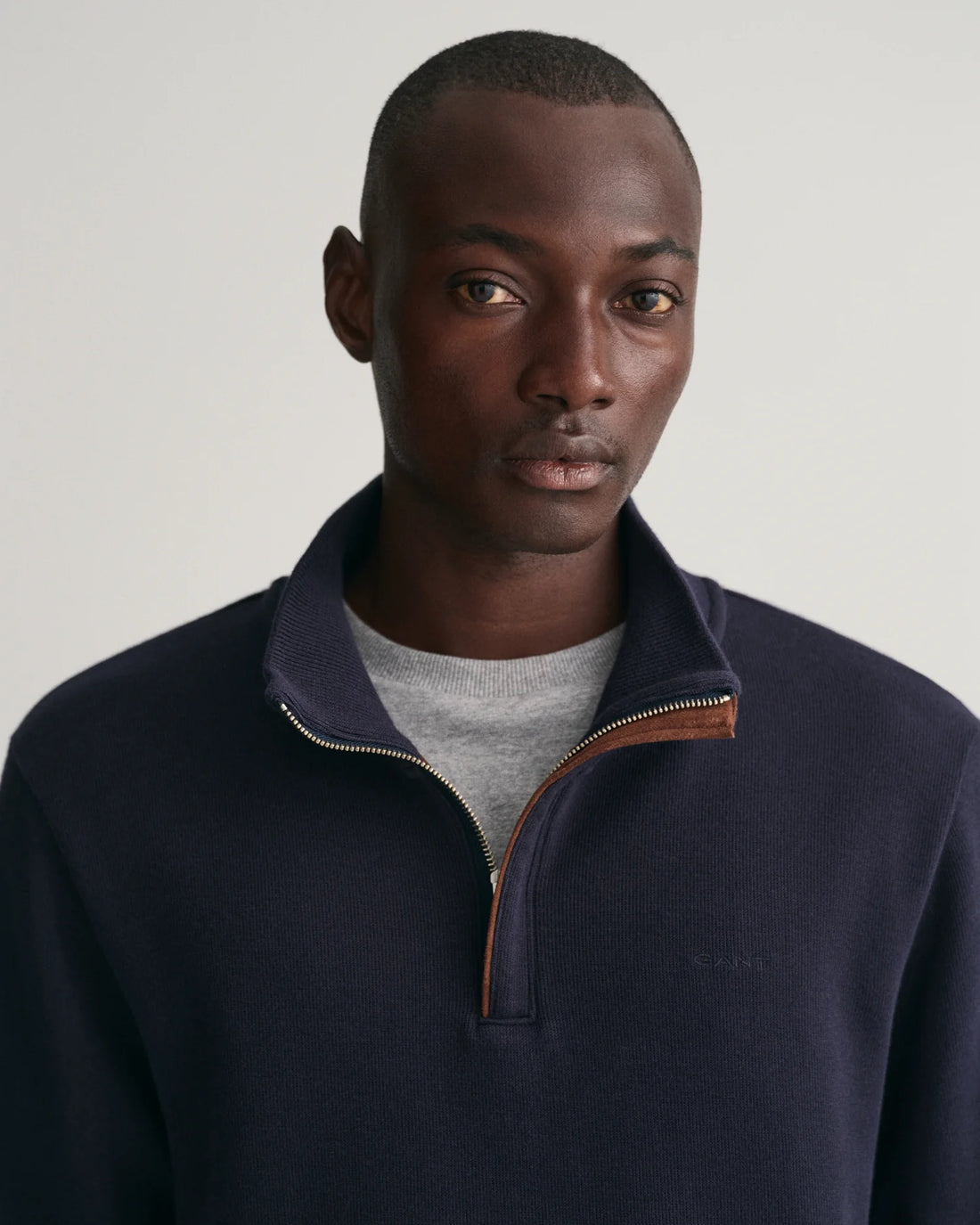 man wearing gant sacker rib half zip sweatshirt in evening blue