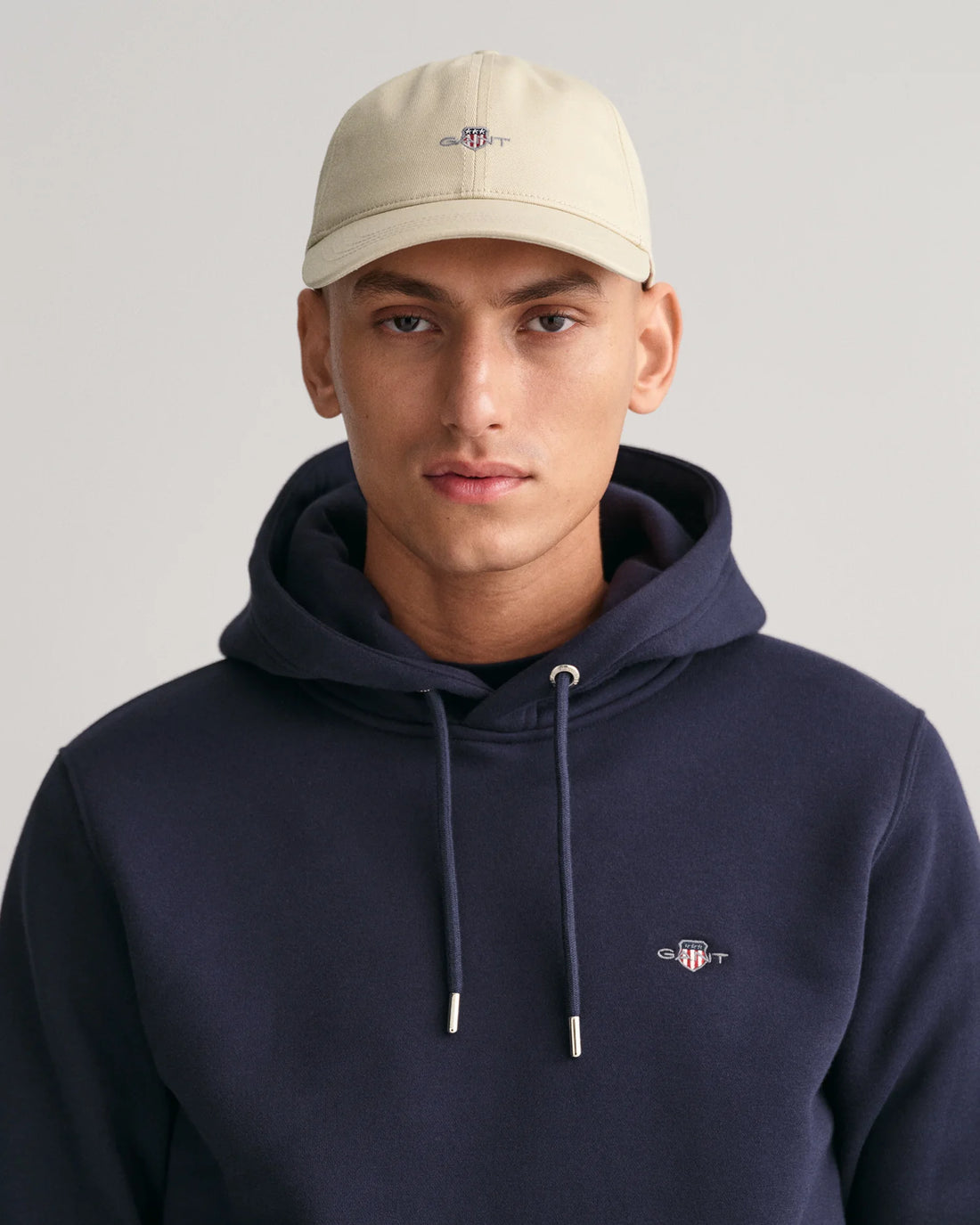 man wearing gant shield cap in putty, hooded jacket