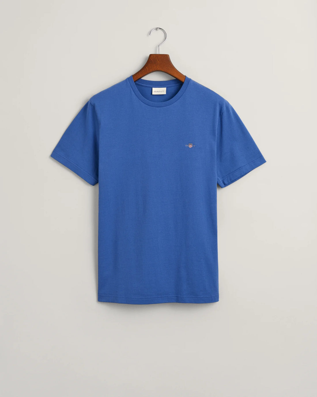gant shield t-shirt in rich blue, navy blue pants and shoes in hanger