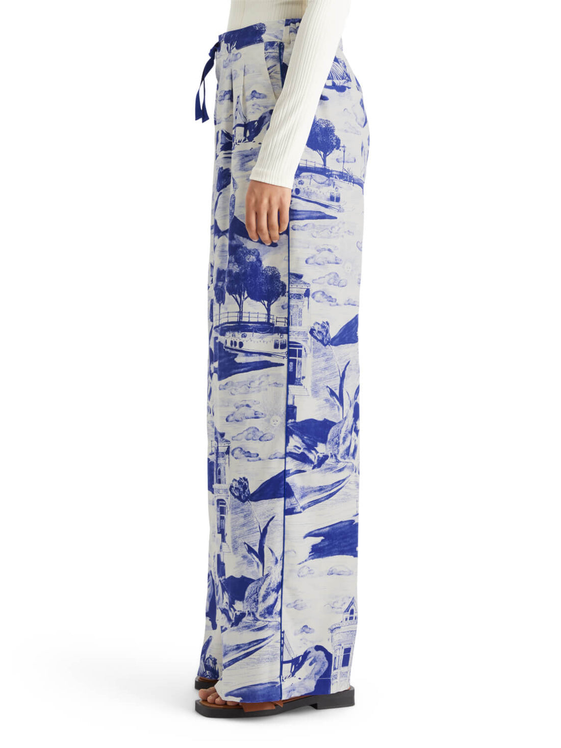 person facing the side wearing white long sleeve top and Eleni Wide Fit Pants - Journey of the Free Mind Print