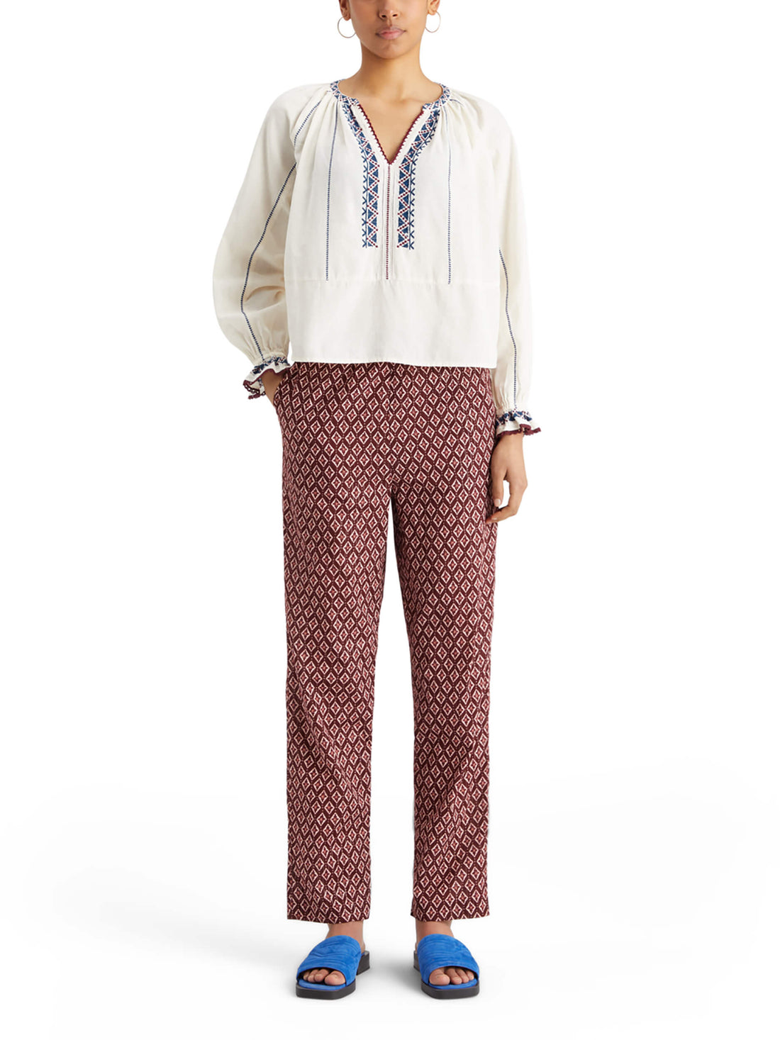 woman wearing Embroidered Blouse - Soft Ice and geo pattern pants