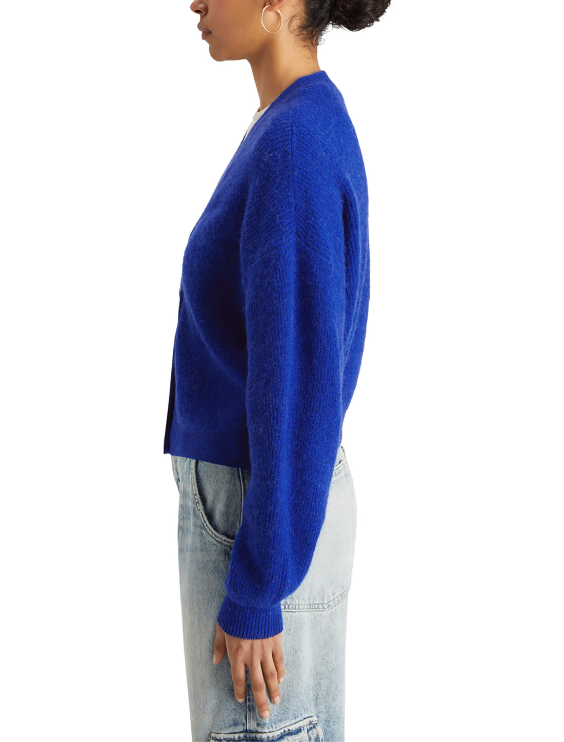 woman facing the side wearing Fuzzy Relaxed Cardigan - Electric Blue and denim pants
