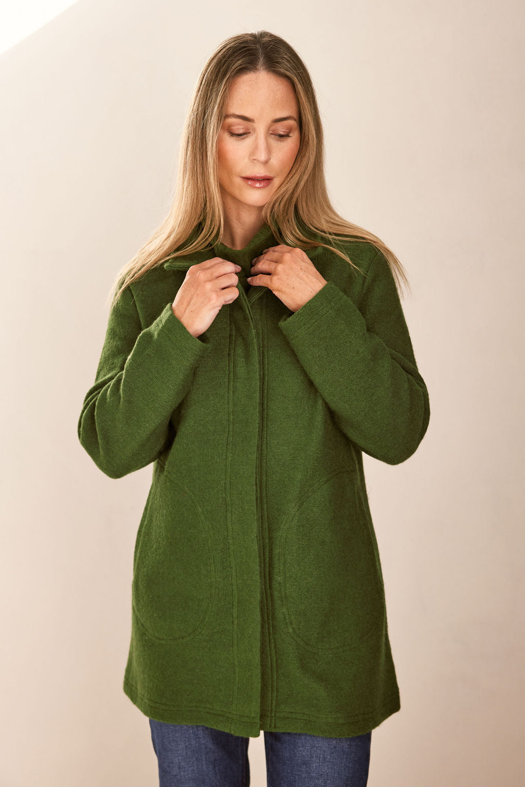 woman wearing Boiled Wool Funnel Neck Coat - Khaki and dark denim pants