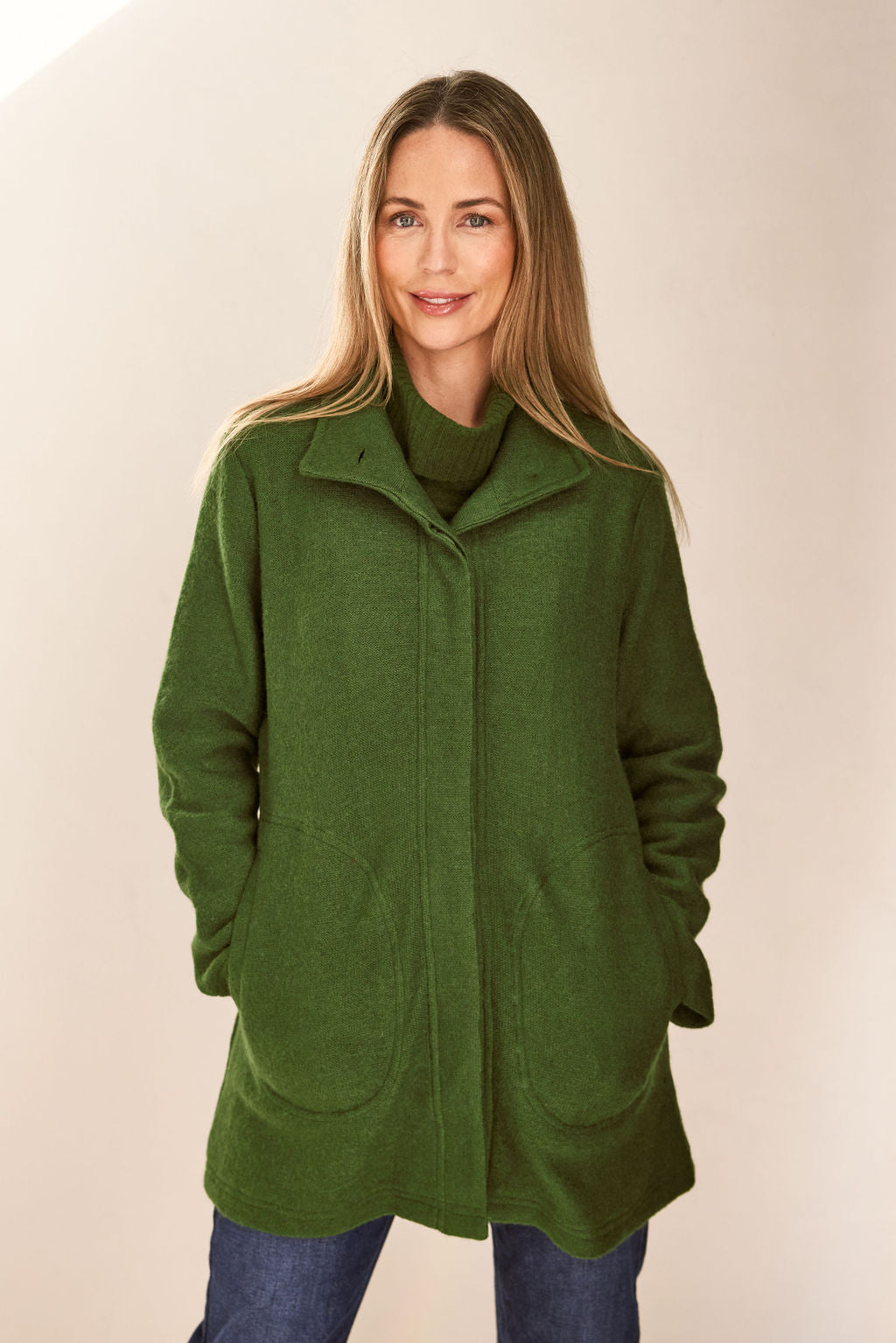 woman wearing Boiled Wool Funnel Neck Coat - Khaki and dark denim pants