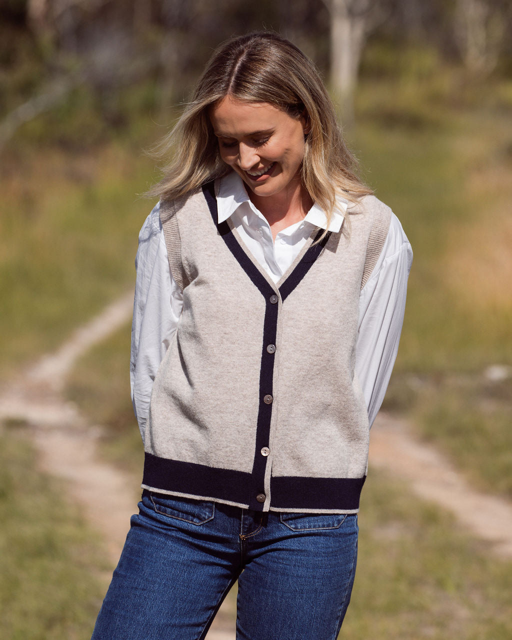 woman wearing white top, 100% Luxe Merino Buttun Front Vest - Natural/Navy and dark denim pants